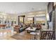 Bright and open living area with dining, fireplace, and patio access at 10811 E Acoma Dr, Scottsdale, AZ 85255
