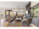 Open living room with fireplace, sleek built-ins, and access to the outdoor patio at 10811 E Acoma Dr, Scottsdale, AZ 85255