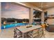 Covered patio featuring an outdoor dining area, comfortable seating, and a view of the pool, perfect for enjoying the outdoors at 10811 E Acoma Dr, Scottsdale, AZ 85255