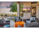 Relaxing covered patio with spa, TV, and comfortable seating for outdoor entertainment at 10811 E Acoma Dr, Scottsdale, AZ 85255