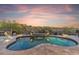 Luxurious pool featuring a waterfall feature and desert landscaping, perfect for relaxation and outdoor enjoyment at 10811 E Acoma Dr, Scottsdale, AZ 85255