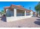 The backyard presents a covered patio offering outdoor relaxation space, set amidst a low-maintenance rock landscape at 1120 N Val Vista Dr # 10, Gilbert, AZ 85234