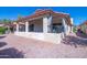 Inviting home exterior showcases a charming covered patio with outdoor seating, complemented by a rock landscaped yard at 1120 N Val Vista Dr # 10, Gilbert, AZ 85234