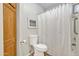 Clean bathroom with a toilet, shower with white curtain, and wooden cabinet at 1120 N Val Vista Dr # 10, Gilbert, AZ 85234