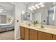 Well-maintained bathroom featuring a double vanity with wood cabinets and neutral walls at 1120 N Val Vista Dr # 10, Gilbert, AZ 85234