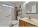 Bathroom featuring a tiled shower and tub, vanity with sink, and mirrored wall cabinet at 1120 N Val Vista Dr # 10, Gilbert, AZ 85234