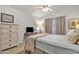 Bright bedroom featuring light blue walls, a ceiling fan, and a cozy floral bedspread at 1120 N Val Vista Dr # 10, Gilbert, AZ 85234