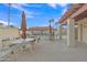 Inviting community pool with shaded seating, tables and umbrellas, perfect for relaxing and enjoying the outdoors at 1120 N Val Vista Dr # 10, Gilbert, AZ 85234