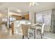 Open concept dining area with kitchen view, ceiling fan, and set table at 1120 N Val Vista Dr # 10, Gilbert, AZ 85234