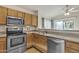Well-lit kitchen featuring stainless steel appliances and ample cabinet space at 1120 N Val Vista Dr # 10, Gilbert, AZ 85234