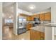 Open kitchen with stainless steel refrigerator and wood cabinets at 1120 N Val Vista Dr # 10, Gilbert, AZ 85234