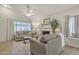 Bright living room with a fireplace, plush seating, and large window views at 1120 N Val Vista Dr # 10, Gilbert, AZ 85234