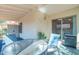 Covered patio with glass table, comfortable seating, and a slider door provides seamless indoor/outdoor living at 1120 N Val Vista Dr # 10, Gilbert, AZ 85234