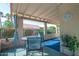 Cozy covered patio with outdoor seating, a round glass table, and views of lush landscaping at 1120 N Val Vista Dr # 10, Gilbert, AZ 85234