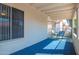 Relaxing covered patio features a blue carpet and neutral stucco walls, perfect for enjoying the outdoors at 1120 N Val Vista Dr # 10, Gilbert, AZ 85234