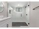 Modern bathroom shower featuring black fixtures, glass doors, and sleek tiling at 113 S Ocean Dr, Gilbert, AZ 85233
