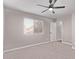 Bright bedroom featuring a ceiling fan, a window with blinds, and neutral colored walls and carpet at 113 S Ocean Dr, Gilbert, AZ 85233