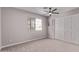 Bedroom with a ceiling fan, window with blinds, closet, and neutral carpet at 113 S Ocean Dr, Gilbert, AZ 85233