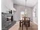 Bright dining room featuring a brick fireplace, wooden table, and modern light fixture at 113 S Ocean Dr, Gilbert, AZ 85233