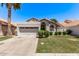 Inviting single-story home with two-car garage, desert landscaping, and red tile roof, framed by a blue sky at 113 S Ocean Dr, Gilbert, AZ 85233