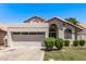 Charming single-story home with a two-car garage, desert landscaping and a red tile roof on a clear, sunny day at 113 S Ocean Dr, Gilbert, AZ 85233
