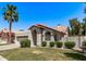 Single-story home with a two-car garage, desert landscaping, and a red tile roof on a sunny day at 113 S Ocean Dr, Gilbert, AZ 85233