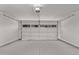 Clean, bright two-car garage with white door and updated lighting at 113 S Ocean Dr, Gilbert, AZ 85233