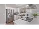 Updated kitchen featuring stainless steel appliances, quartz counters, and ample cabinet space at 113 S Ocean Dr, Gilbert, AZ 85233