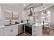 Well-lit kitchen with stainless steel appliances, light countertops, and a dining area at 113 S Ocean Dr, Gilbert, AZ 85233
