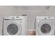 New washer and dryer set in laundry room on wood flooring at 113 S Ocean Dr, Gilbert, AZ 85233