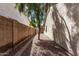 Gravel side yard featuring brick wall and shade tree at 113 S Ocean Dr, Gilbert, AZ 85233