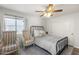 Charming bedroom with a ceiling fan, sliding closet, and large window that fills the space with light at 11333 N 92Nd St # 2049, Scottsdale, AZ 85260