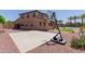Large backyard complete with a basketball court, well-maintained landscaping, and lush green palm trees for outdoor fun at 11466 N 162Nd Ln, Surprise, AZ 85379