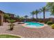 Inviting backyard with a kidney-shaped pool, desert landscaping, and a shaded pergola seating area, great for outdoor relaxation at 11466 N 162Nd Ln, Surprise, AZ 85379