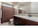 Bathroom with granite counters and framed mirror over the dark wood vanity and sink at 11466 N 162Nd Ln, Surprise, AZ 85379
