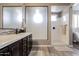 Modern bathroom includes a double vanity, stylish fixtures, and a walk-in shower at 11466 N 162Nd Ln, Surprise, AZ 85379