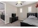 Bedroom area with a cozy bed, built-in bookcase, and adjacent landing at 11466 N 162Nd Ln, Surprise, AZ 85379