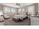 Inviting bedroom showcases soft neutral tones, plush carpeting, and abundant natural light through large windows at 11466 N 162Nd Ln, Surprise, AZ 85379