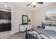 Comfortable bedroom with dresser, decorative mirror, and ensuite bathroom entrance at 11466 N 162Nd Ln, Surprise, AZ 85379