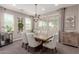 Bright dining room with an elegant chandelier, neutral window coverings, and seating for six at 11466 N 162Nd Ln, Surprise, AZ 85379