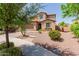 Beautiful home exterior featuring a well-kept lawn, desert landscaping, and a welcoming front entrance at 11466 N 162Nd Ln, Surprise, AZ 85379