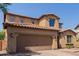 Two-story home with a tile roof, a spacious garage, and low-maintenance desert landscaping at 11466 N 162Nd Ln, Surprise, AZ 85379