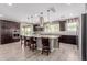 Gourmet kitchen with stainless steel appliances, a spacious island, and dark wood cabinetry at 11466 N 162Nd Ln, Surprise, AZ 85379