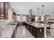 Open-concept kitchen boasts granite countertops, a large center island, and seamless flow to living area at 11466 N 162Nd Ln, Surprise, AZ 85379