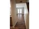 View of the living room with attractive wood-look floors, accessible through a welcoming hallway at 12245 N 21St Ave # 1, Phoenix, AZ 85029