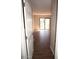 Hallway view into a light-filled living space with sliding glass doors opening to a patio at 12245 N 21St Ave # 1, Phoenix, AZ 85029