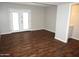 Bright living room with wood-look floors and glass doors leading to outdoor space at 12245 N 21St Ave # 1, Phoenix, AZ 85029