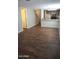 Open-concept living space with wood-look floors, leading into the kitchen area and other living spaces at 12245 N 21St Ave # 1, Phoenix, AZ 85029