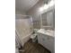 Bathroom with a shower-tub combo and a white vanity at 12422 N 121St Dr, El Mirage, AZ 85335