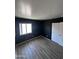 Bedroom with wood-look flooring and natural light at 12422 N 121St Dr, El Mirage, AZ 85335